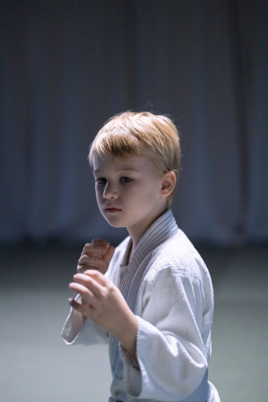 a boy wearing white karate gi